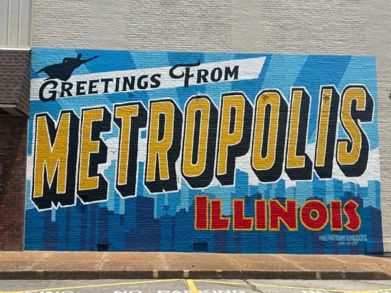 "Colorful 'Greetings from Metropolis Illinois' wall mural painted on downtown building, showcasing local charm and city pride"